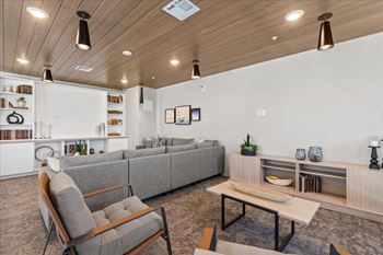 Room with grey couch and chairs