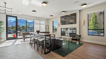 A modern living room with a view of the mountains outside the window.