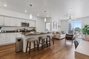 St. George apartment for rent - an open kitchen and living room with a large island and stools at City View St. George Apartments, St George, UT, 84770