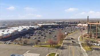 Parking lot with cars and a shopping center in the background