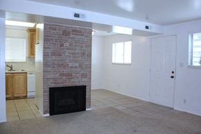 Orem apartment for rent - A room with a fireplace and a door.