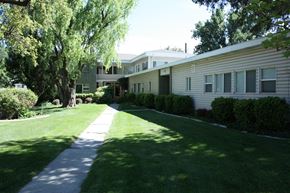 Provo apartment for rent - A pathway leads through a grassy area in front of apartment buildings.