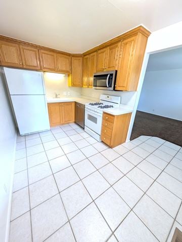 Provo apartment for rent - A kitchen with wooden cabinets and white appliances.