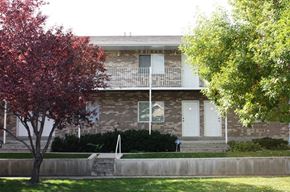 Provo apartment for rent - A house with a white door and a tree in front.