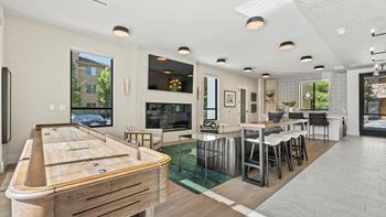 A billiard table is in the middle of a well-furnished room.