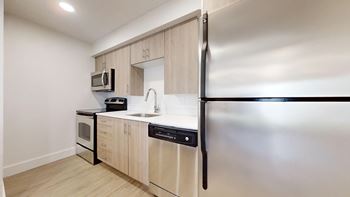 Modern kitchen with wooden cabinet and a marble counter top