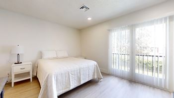 Beautiful bright bedroom with wide windows