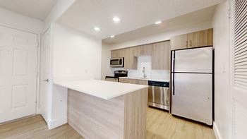 Kitchen with refrigerator and white cabinets