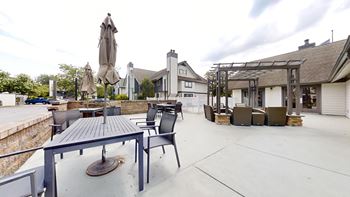 A patio with a table and chairs