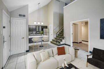 Indianapolis apartment for rent - A living room with a white couch and a black chair.