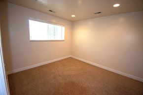 Provo apartment for rent - A room with a carpeted floor and a window.