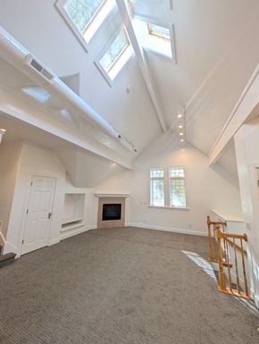 Provo apartment for rent - A spacious room with a fireplace and skylights.