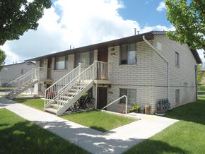 Orem apartment for rent - A building with a white staircase and a bicycle in front of it.