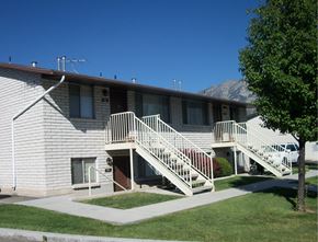 Orem apartment for rent - A building with a staircase leading to the front door.