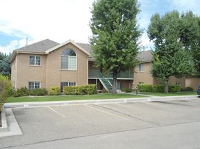 Orem apartment for rent - A large building with a parking lot in front of it.