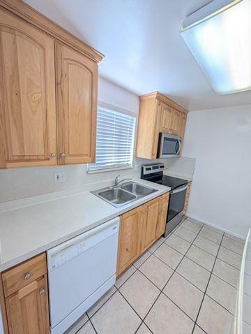 Orem apartment for rent - A kitchen with wooden cabinets and a white dishwasher.