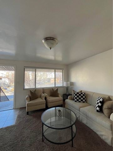 Orem apartment for rent - A living room with a glass table and two couches.