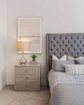 Provo apartment for rent - a bedroom with a bed with a tufted headboard and a night stand at 200 City View, Utah