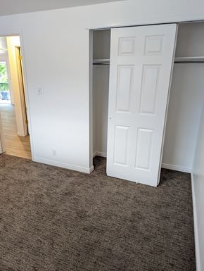 Orem apartment for rent - A white door is open in a room with carpeted floor.