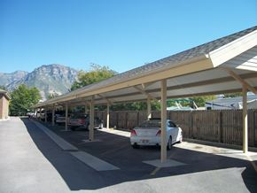 Orem apartment for rent - A long covered parking lot with cars parked in it.