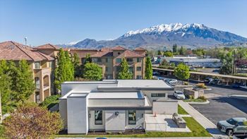 A modern building with a mountain in the background.