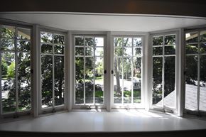 Provo apartment for rent - A sunny day with a view of trees through a set of white windows.