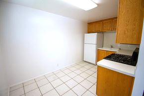 Provo apartment for rent - A kitchen with white appliances and wooden cabinets.