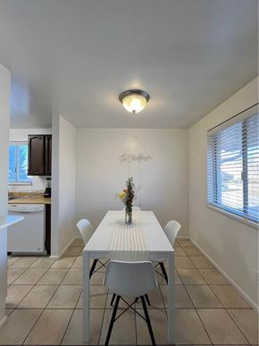 Orem apartment for rent - A dining room with a white table and chairs.