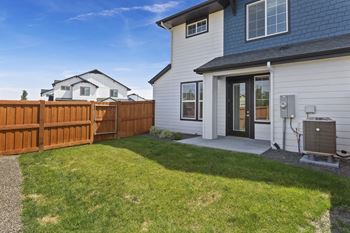 A house with a brown fence and a grey roof.