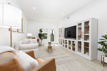 St. George apartment for rent - A living room with a brown leather couch and a white sofa.
