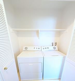 Orem apartment for rent - A small laundry room with a washer and dryer.