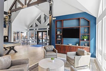 Overland Park apartment for rent - a living room with a blue wall and a table and chairs