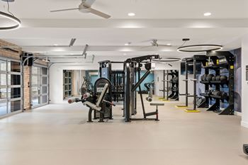 A spacious gym with a variety of equipment.