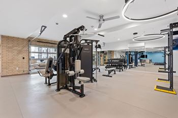 A gym with a variety of equipment including a leg press machine.