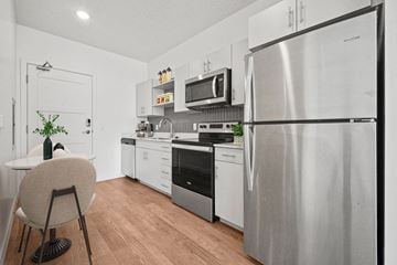 Salt Lake City apartment for rent - an apartment kitchen with stainless steel appliances and a table