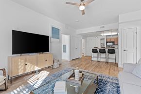 Ogden apartment for rent - a living room with a tv and a kitchen in the backgroundat The View on 20th, Ogden, 84401
