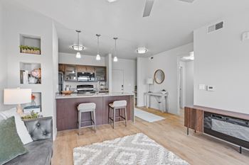 A modern kitchen with a bar area and a dining table.