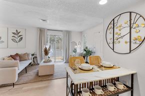 Jacksonville apartment for rent - a living room and dining room with a table and chairs at AVIA Lofts on Liberty Ridge Apartments, Jacksonville 32256