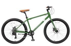 A green bike with a brown seat is shown.