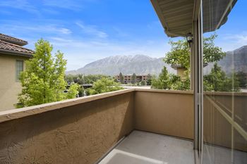 A balcony with a view of a mountain range.