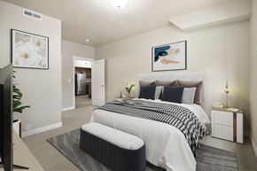 Orem apartment for rent - a bedroom with a bed and a chair in a room at Siena Villas Apartments, Orem, UT