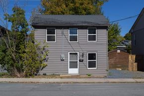 Kingston apartment for rent - A grey house with a white door and windows.
