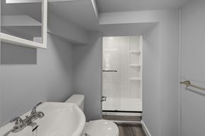Kingston apartment for rent - A white sink in a bathroom with a toilet and a shower.