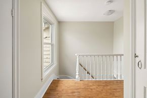 Kingston apartment for rent - A white interior with a wooden floor and a staircase.