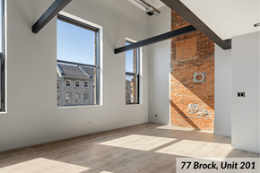 Kingston apartment for rent - A room with a brick wall and a window overlooking a building.
