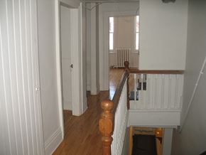 Kingston apartment for rent - a view of the hallway from the top of the stairs looking into the living room