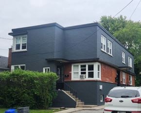 Kingston apartment for rent - A grey house with a white car parked in front.