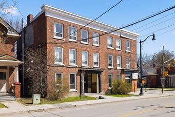 Kingston apartment for rent - A red brick building with a black door and windows.