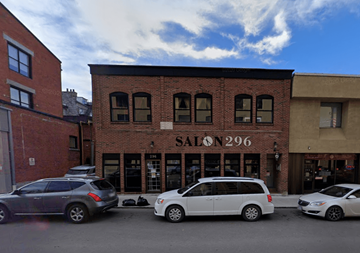 Kingston apartment for rent - A white van is parked in front of a salon.