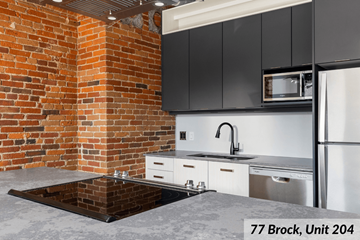 Kingston apartment for rent - A kitchen with a brick wall and a sink.